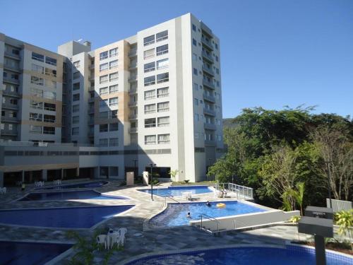 a building with two pools in front of a building at Rio Quente Flat Veredas Apto - 231 in Rio Quente