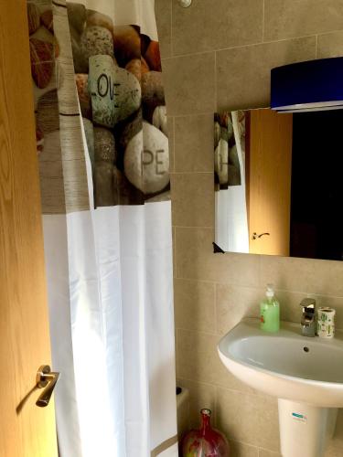 a bathroom with a sink and a mirror at Single room in private house el rompido in El Rompido