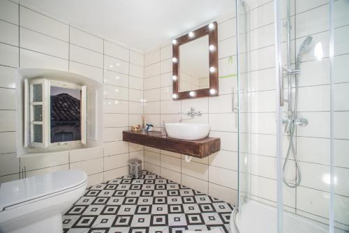 a bathroom with a sink and a toilet and a mirror at 4 Limuna in Janjina