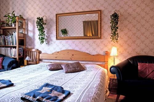 a bed sitting in a bedroom next to a window at Eklanda Bed & Breakfast in Gothenburg