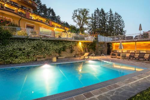 uma grande piscina em frente a um edifício em Alp Wellness Sport Hotel Panorama em Fai della Paganella
