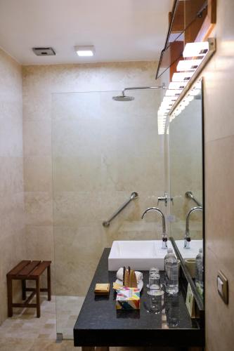 a bathroom with a sink and a mirror at Tocuyeros Boutique Hotel in Cusco