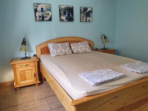 a bedroom with a wooden bed with two pillows on it at La Colline de Chott Meriem appartements in Sousse