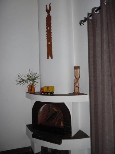 a fireplace with a toy train on top of it at Ecole Lodge Antananarivo in Mahitsy