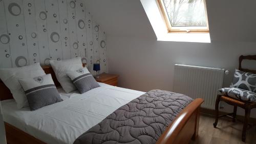 a bedroom with a bed and a window at les hortensias in Saint-Just