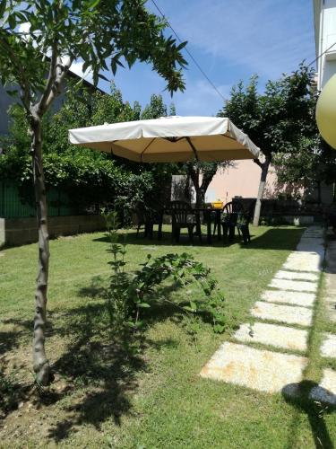 a large umbrella in a yard with a table at Short Lets Pescara in Pescara