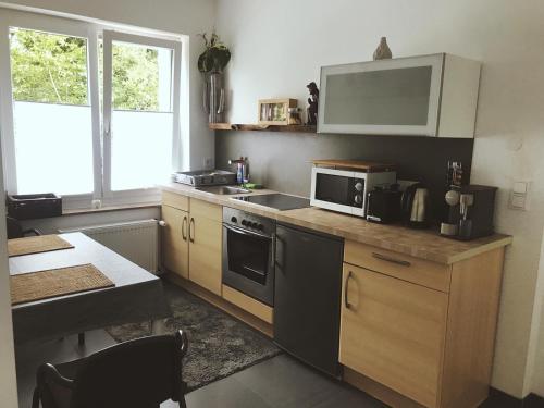 a kitchen with a counter with a microwave and a sink at Robert Koch in Arnsberg