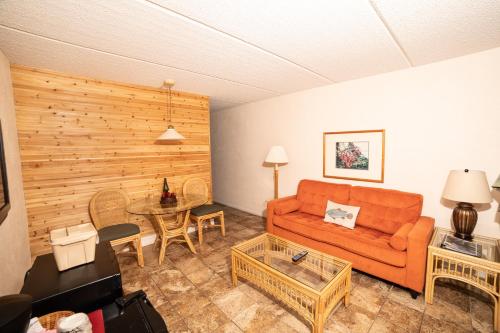 a living room with an orange couch and a table at Steinhatchee River Inn and Marina in Steinhatchee