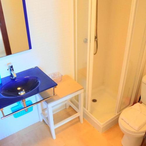 a bathroom with a blue sink and a shower at Casa Nemo Cotillo Mar in El Cotillo