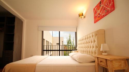 a bedroom with a white bed and a balcony at Puerto Tigre in Tigre