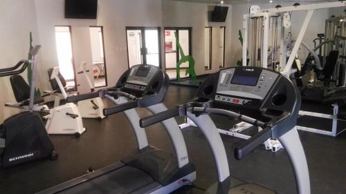 a gym with several treadmills and cardio machines at Casa Grande Chihuahua in Chihuahua
