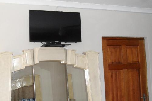 a flat screen tv on top of a wall at Garden Wing in Upington