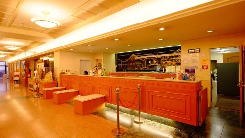 a restaurant with a bar with red counters and toilets at Okuhida Garden Hotel Yakedake in Takayama