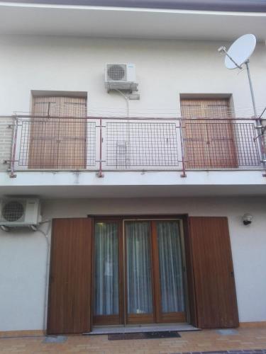 an apartment building with a balcony and a heater at Affittacamere Nerio in Ronchi dei Legionari