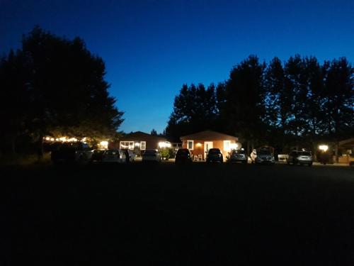 a group of cars parked in a parking lot at night at Country Dream - Langholt 2 in Selfoss