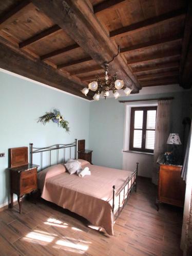 a bedroom with a bed and a wooden floor at La Rocca di Efisio in Costigliole dʼAsti