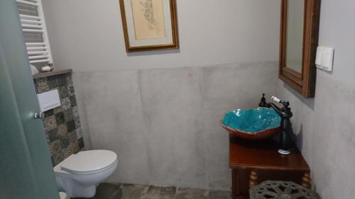 a bathroom with a toilet and a sink at Gościnna Prowansja in Łuków