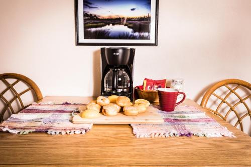 a table with a coffee maker and a cutting board with onions at Steinhatchee River Inn and Marina in Steinhatchee