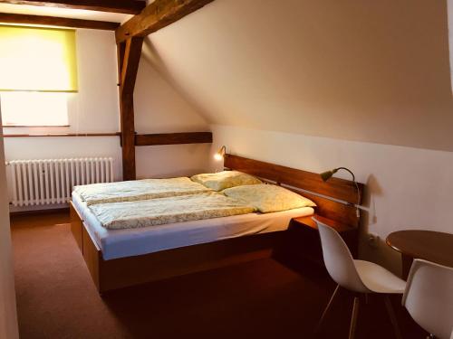 a bedroom with a bed and a table and chairs at Ubytování Doma in Tisá