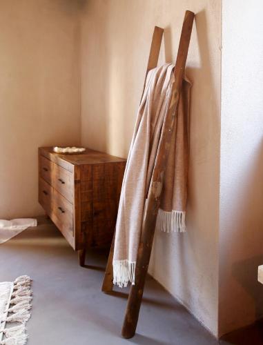 a towel hanging on a wall next to a dresser at Casa Nostra Boutique Hotel & Spa in Palermo