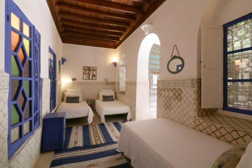 Posteľ alebo postele v izbe v ubytovaní Riad Merstane Marrakech