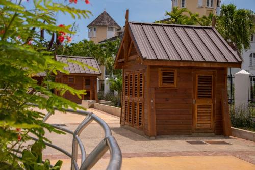 a small wooden building with a metal roof at Ocho Rios Vacation Resort Property Rentals in Ocho Rios