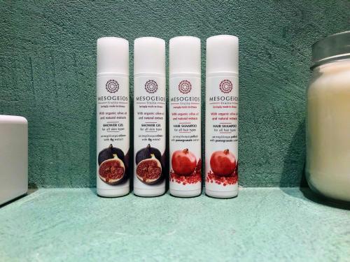 a group of four bottles of lip moisturizers and a jar of milk at ZEN Minimal Luxury Housing Tyros in Tiros