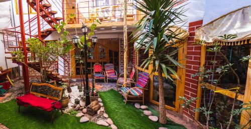 a patio with chairs and plants in a building at Villa Betty B&B in Cusco