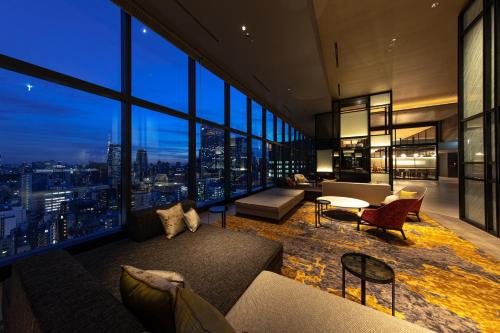 a living room with a view of a city at THE BLOSSOM HIBIYA in Tokyo