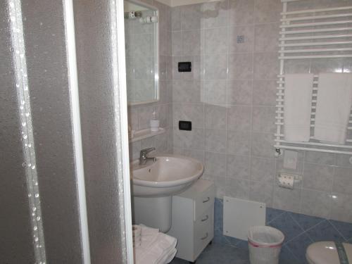 a small bathroom with a sink and a toilet at Meublè Blue House in Auronzo di Cadore