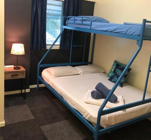 a bedroom with two bunk beds and a lamp at Chill Backpackers in Brisbane