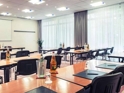 a conference room with tables and chairs with bottles on them at Mercure Hotel Düsseldorf Neuss in Neuss