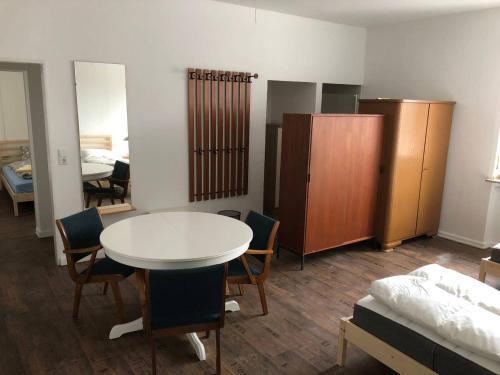 a room with a table and chairs and a bedroom at Mühlweg-Appartment in Alzenau in Unterfranken