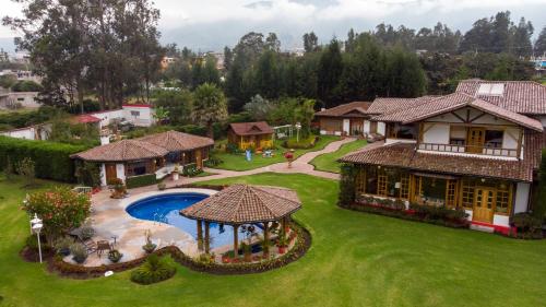 an aerial view of a house with a swimming pool at Casa d'Campo Tababela Hotel Boutique in Tababela