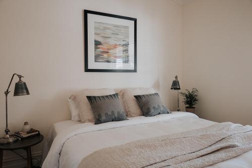 a bedroom with a white bed with two pillows at Apartments on Belmore -The Ferguson in Yarrawonga