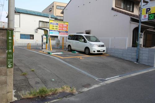 a white van is parked at a gas station at マンションロアジス 大阪市東淀川区相川 in Osaka