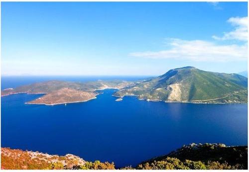 a view of a large body of water with mountains at Iriana Village Inn in Stavros