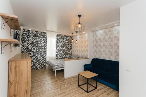 a living room with a blue couch and a table at Elegant apartment 1 in Sumy
