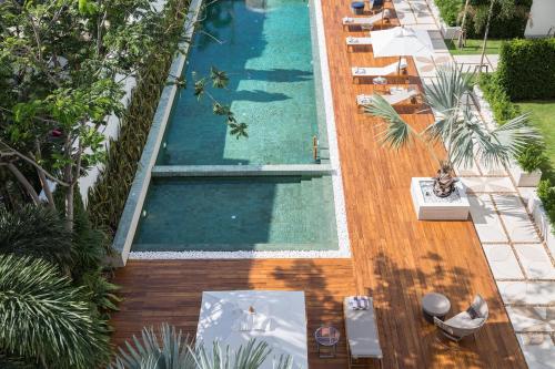 an overhead view of a swimming pool with tables and chairs at Chi - The Residence in Bophut 
