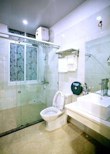 a bathroom with a toilet and a shower and a sink at DREAM HOTEL Bắc Ninh in Hòa Ðình