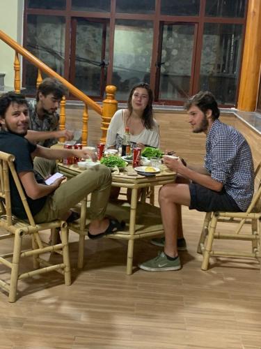 a group of people sitting around a table eating food at Khuổi Ky Eco Homestay in Cao Bằng