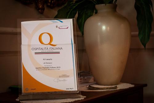 a box on a table next to a vase at Al Lunario in Cherasco