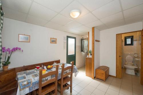 a dining room with a table and a toilet at Camping La Pineta in Viareggio