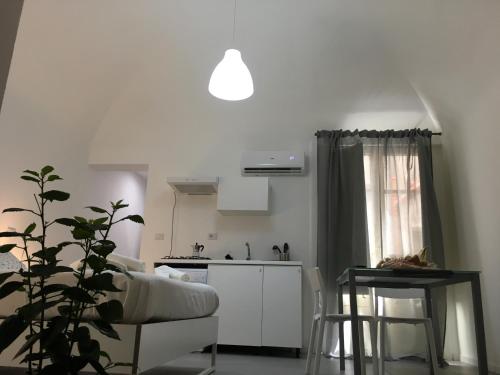 a living room with a couch and a kitchen at FREE FLAT in Catania