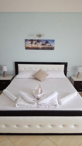 a white bed with white towels on it at Ria mare in Qeparo