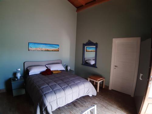 a bedroom with a bed and a mirror and a door at L.T. METIS in Acireale