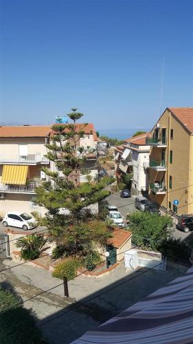 a tree on a street in a city with buildings at Giusy's Place 2.0 in Campofelice di Roccella