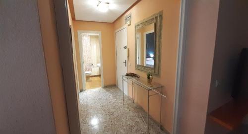 a hallway with a bathroom with a mirror and a sink at Alicante & Urban Center in Alicante