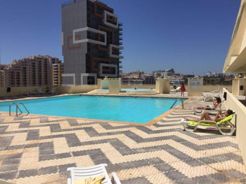 a swimming pool on the roof of a building at Portugal Algarve Beach Apartment in Portimão