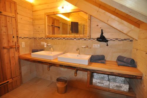 Baño con 2 lavabos en una cabaña de madera en Jörgnerhaus, en Kals am Großglockner